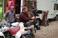 Crew setting up camera on a four wheeler. 